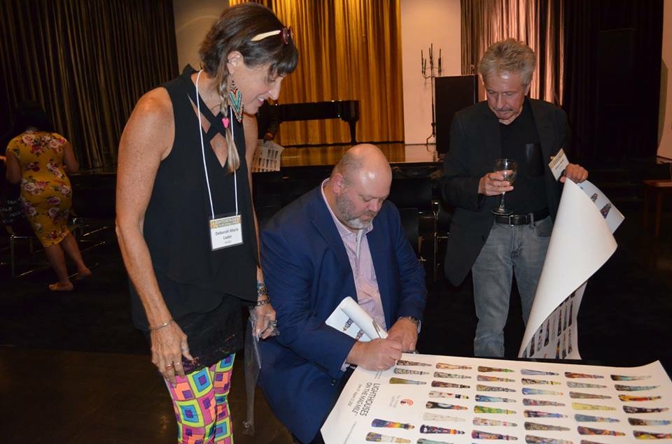 Signing posters with fellow artists Deborah and Didier
