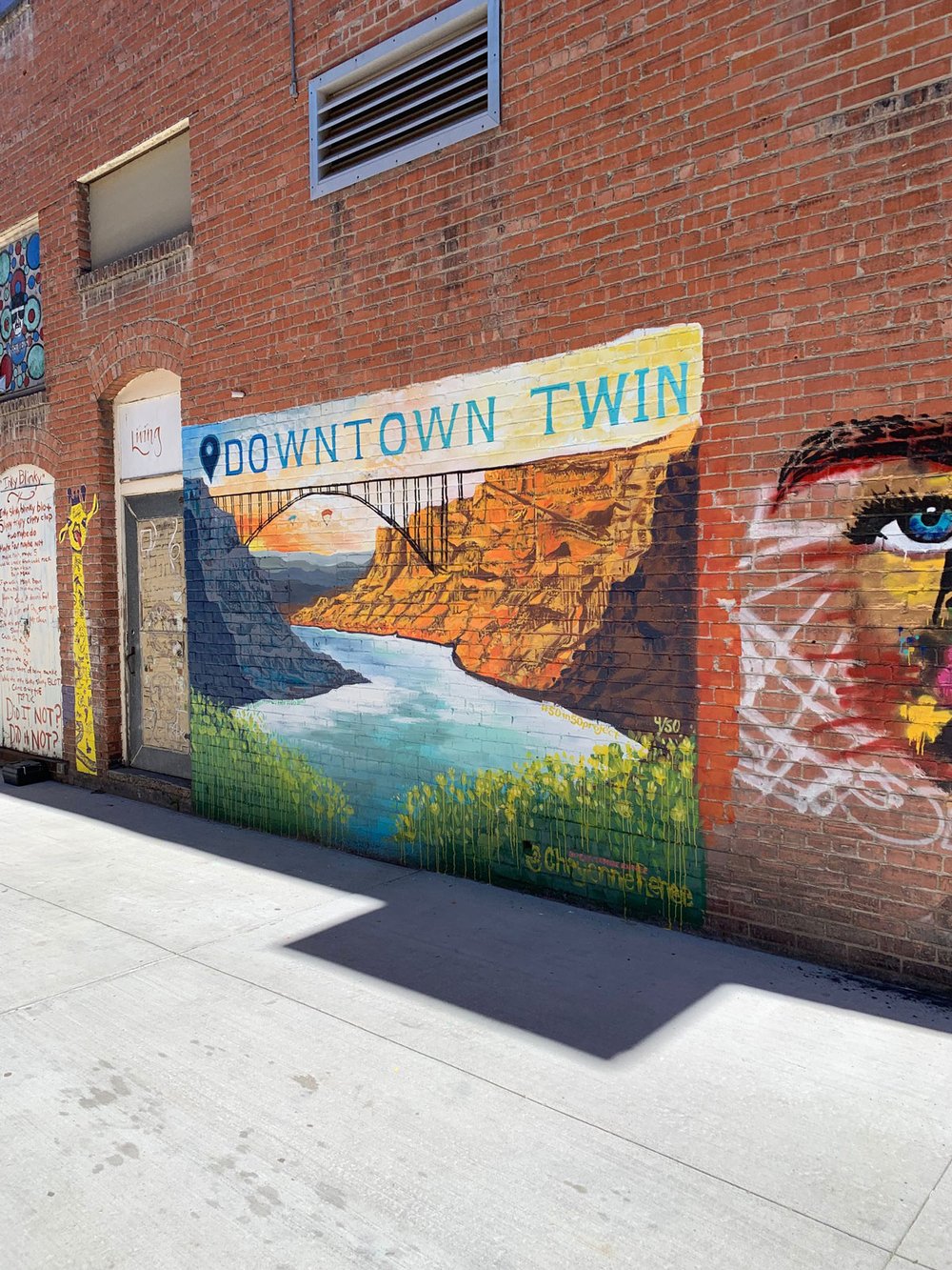 Street art of the Twin Falls bridge on a brick wall.